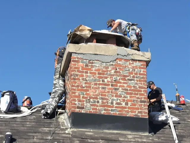 Parma Heights Chimney Sweep installing a custom chimney crown in Parma Heights, OH
