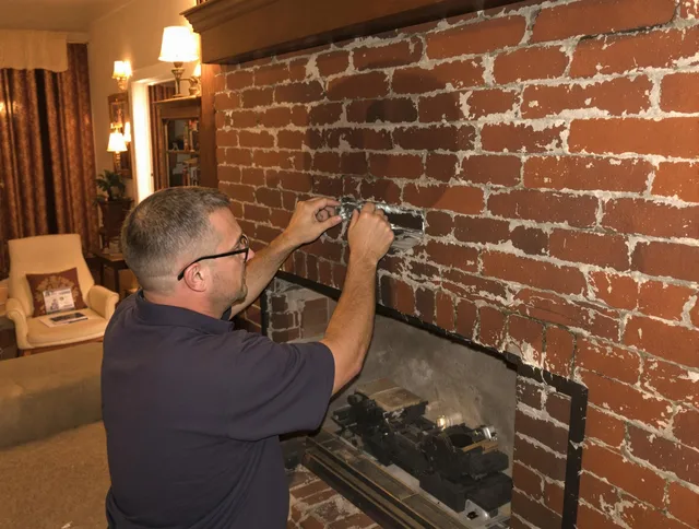 Parma Heights Chimney Sweep expert fixing a fireplace in Parma Heights, OH